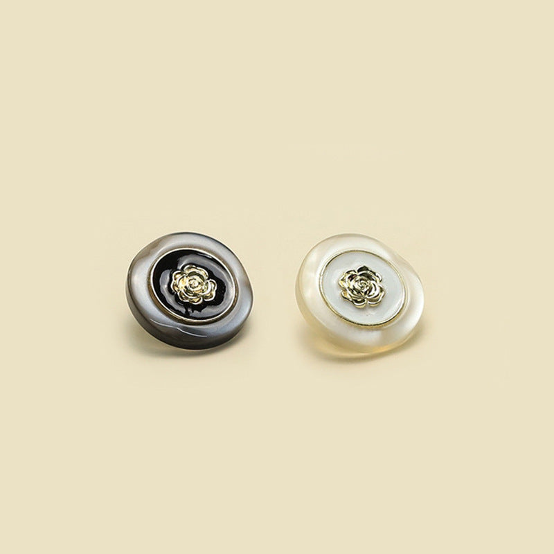 Set of two camellia buttons: black and white resin with gold-tone metal centers