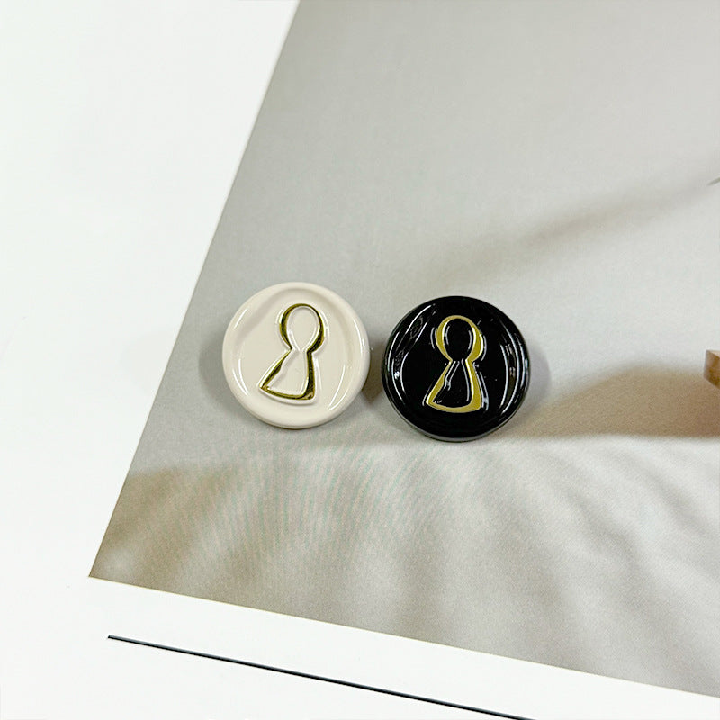 Two 23mm round buttons: white and black with golden-lined miniature figure icons