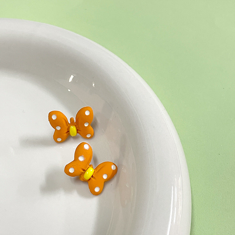 Orange cartoon bow metal shank button, 15x12mm, yellow center, 2 front views