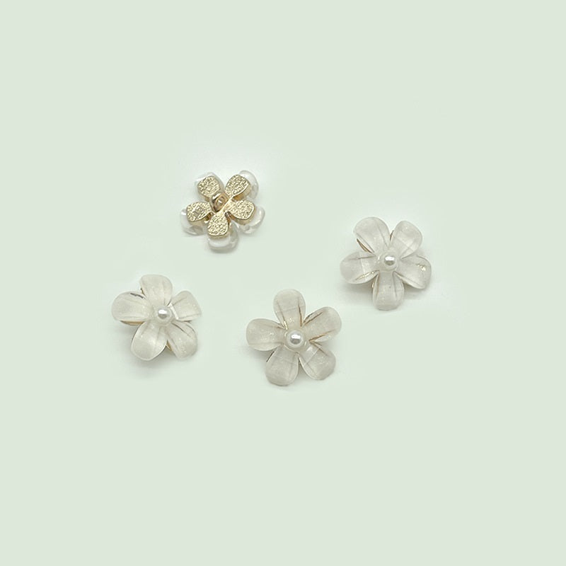 Pearl flower transparent shank buttons, four shown, metal loop center