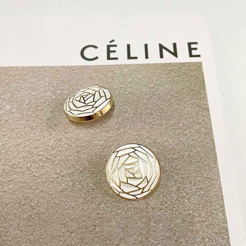 White woven floral metal button with geometric flower-core pattern and gold trim