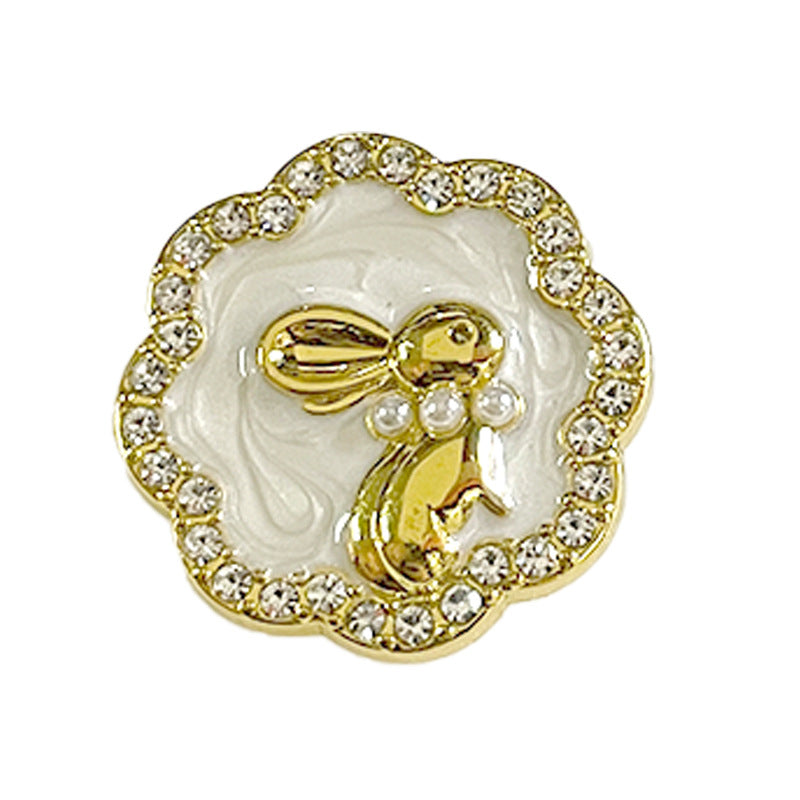 Gold bunny suit button with pearl inlay and rhinestone border