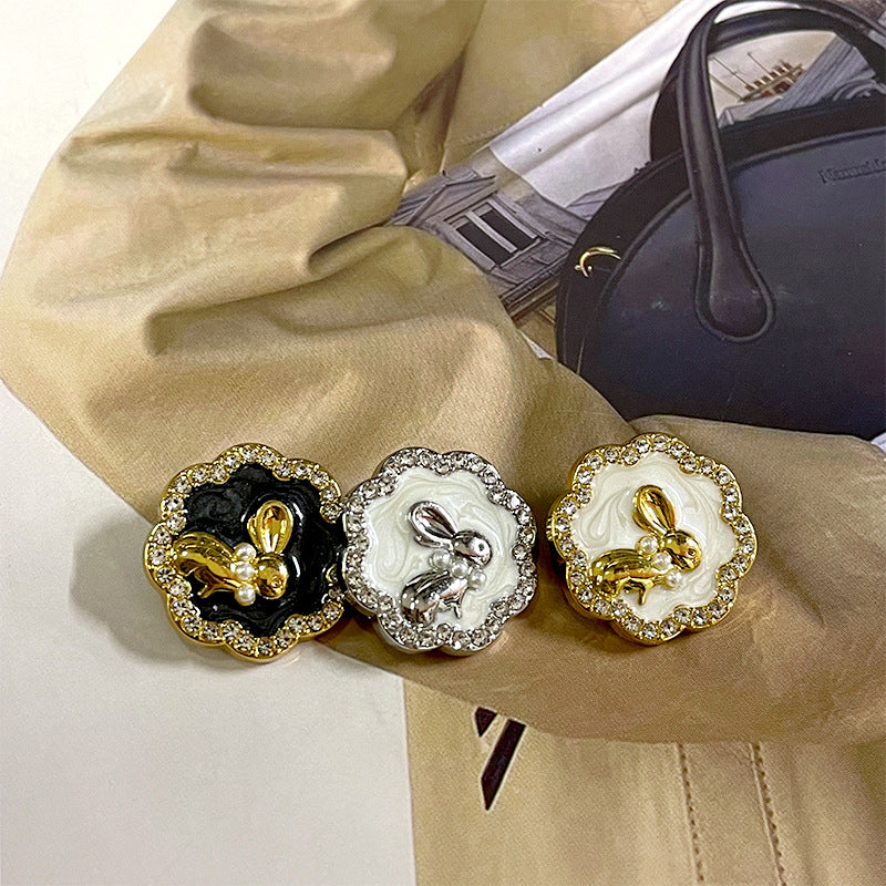 Set of three bunny suit buttons: black, silver-white, and gold with rhinestones