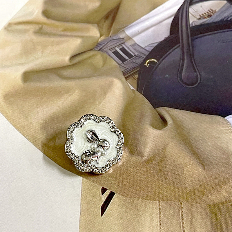 Silver-white bunny suit button with pearl inlay, rhinestone edge, and rabbit charm