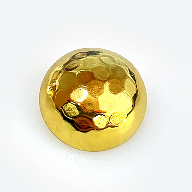 Gold mushroom-shaped shiny metal button with shank, reflective textured front