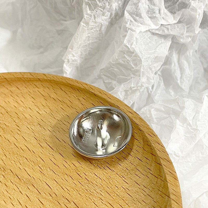 Silver mushroom-shaped metal button back with 2-prong shank, domed metal base