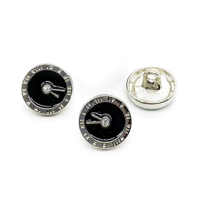 Two black enamel clock buttons with silver-tone rim; silver-toned backs shown