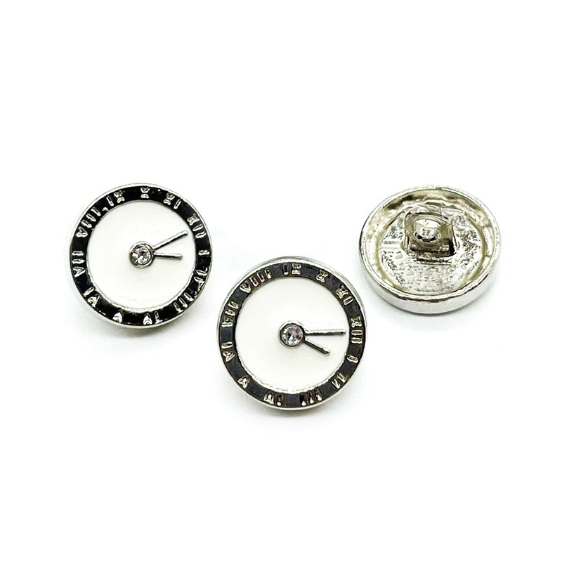 Two front clock buttons: white enamel faces with black rim; silver-tone back visible