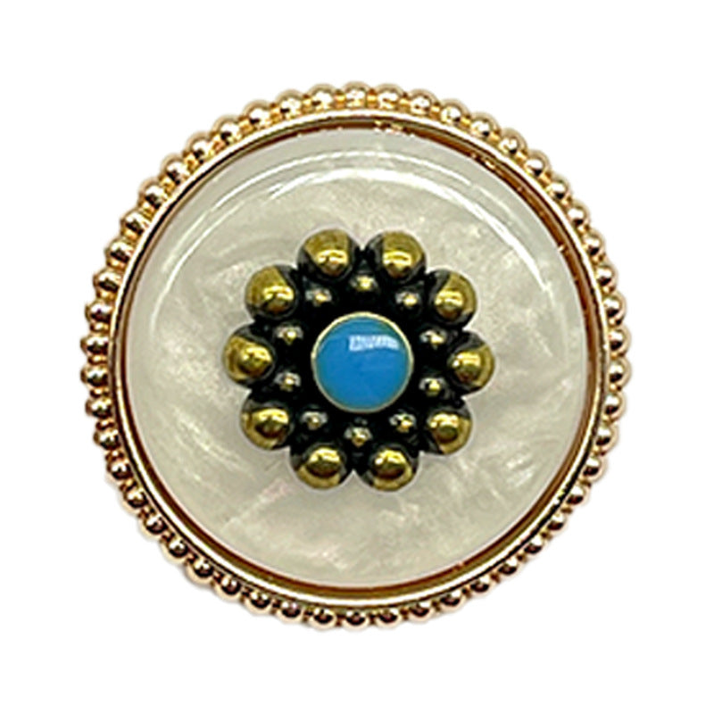 Round vintage plum blossom button close-up, gold beaded border, black face, blue center