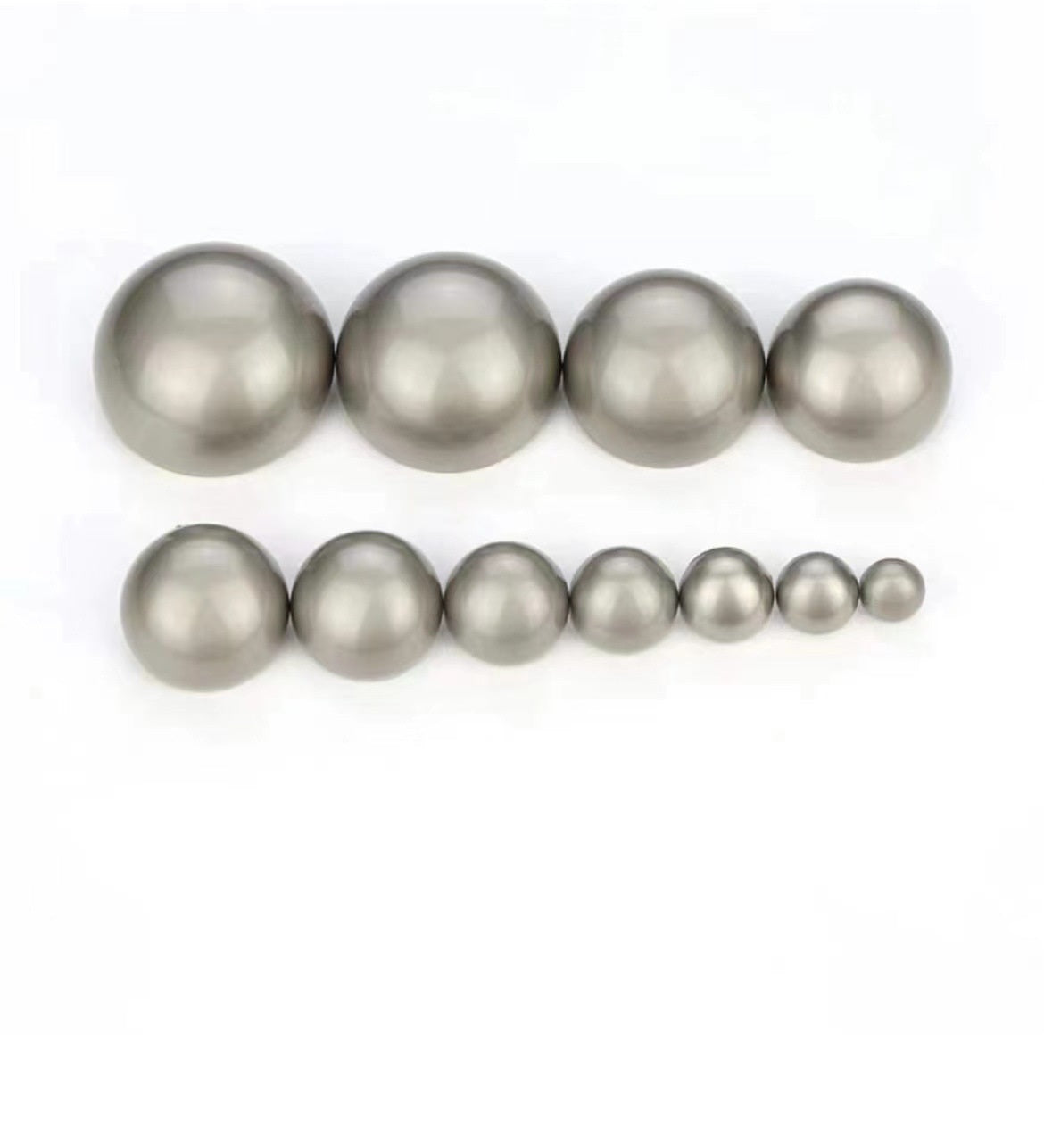Assorted misty silver mushroom buttons in multiple sizes, glossy metal