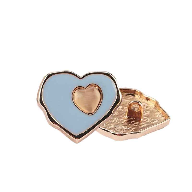 Light blue heart sewing button with metal back and rose-gold tone heart insert