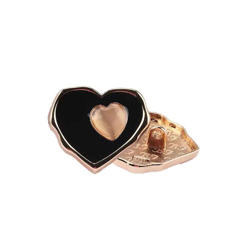 Black heart sewing button with gold-tone back and raised heart center