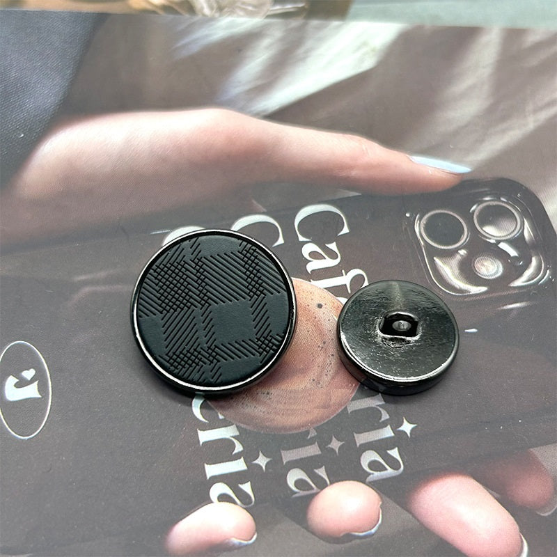 Gun black resin twill button—engraved front with metal shank visible on reverse