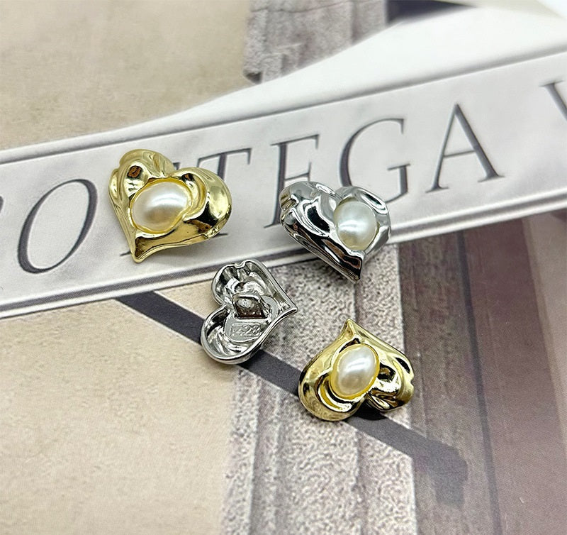 Heart-shaped pearl buttons in gold and silver metal, each with white round center
