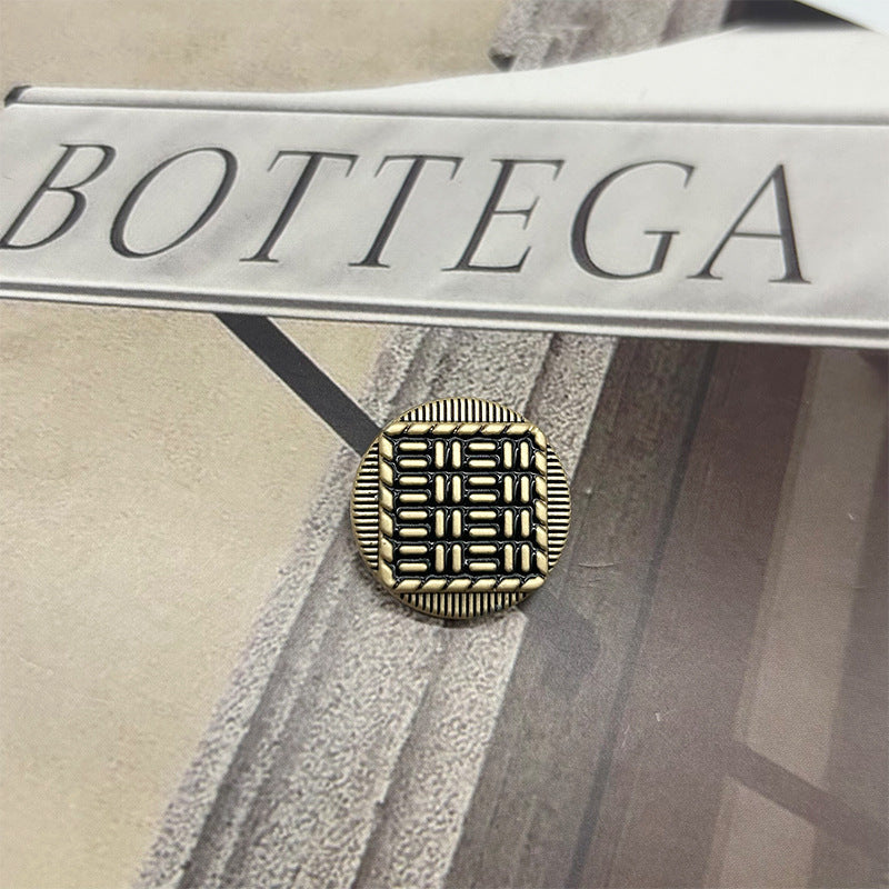 Vintage metal button: round exterior with striped raised pattern, gold-tone