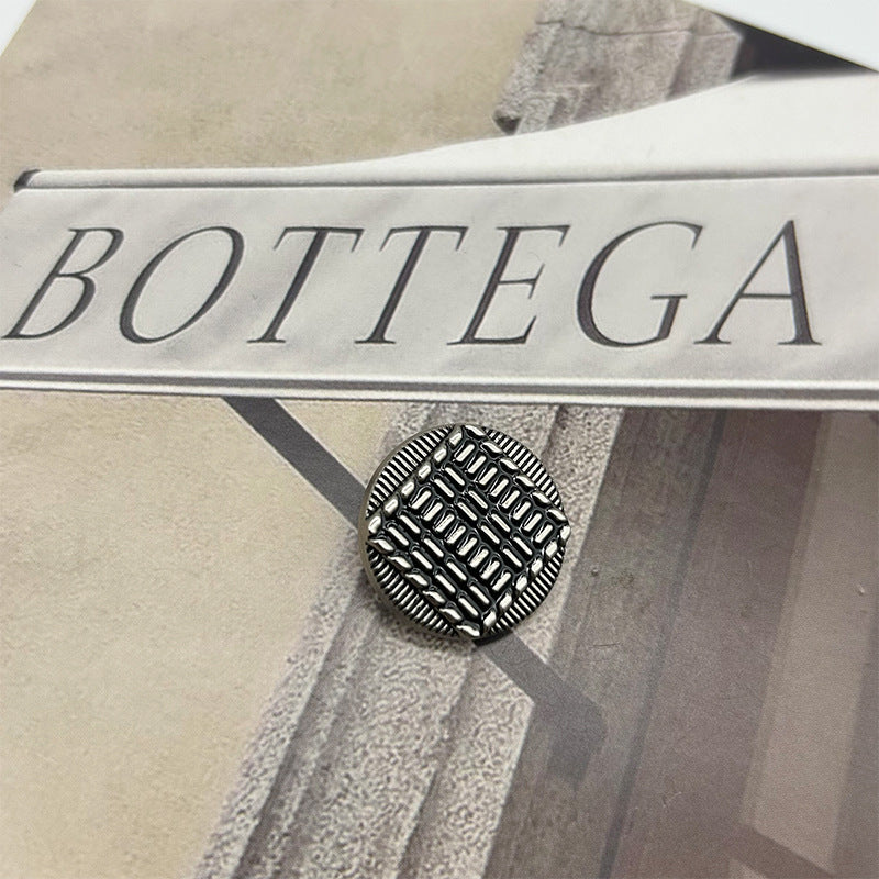 Vintage metal button: round exterior with striped raised pattern, silver-tone