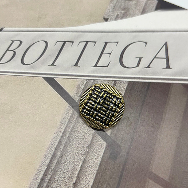 Vintage metal button: round exterior with striped raised pattern, bronze-tone