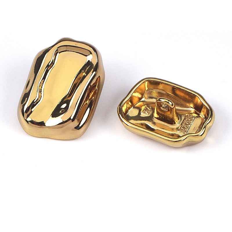 Gold irregular metal shank button, front and back
