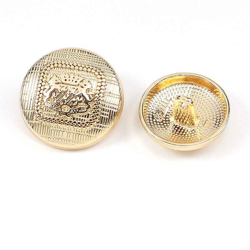 Gold speckled round metal shank button, embossed crest design (2 front views)