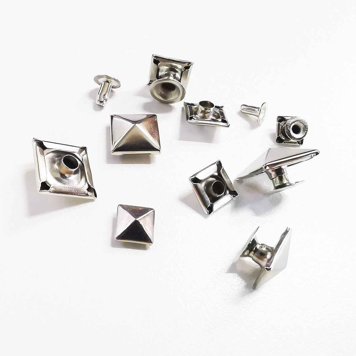 Silver-tone metal pyramid stud rivet buttons set, square backs and spike tops