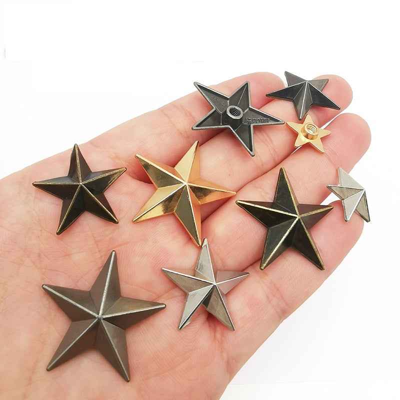 Mixed star rivet screws held in hand, star studs in gold, silver and dark finishes
