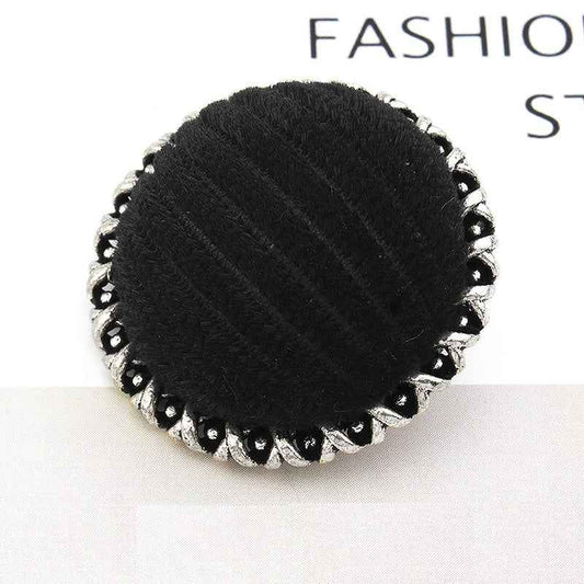 Black velvet-wrapped metal button, lace-edged scalloped rim, textured center