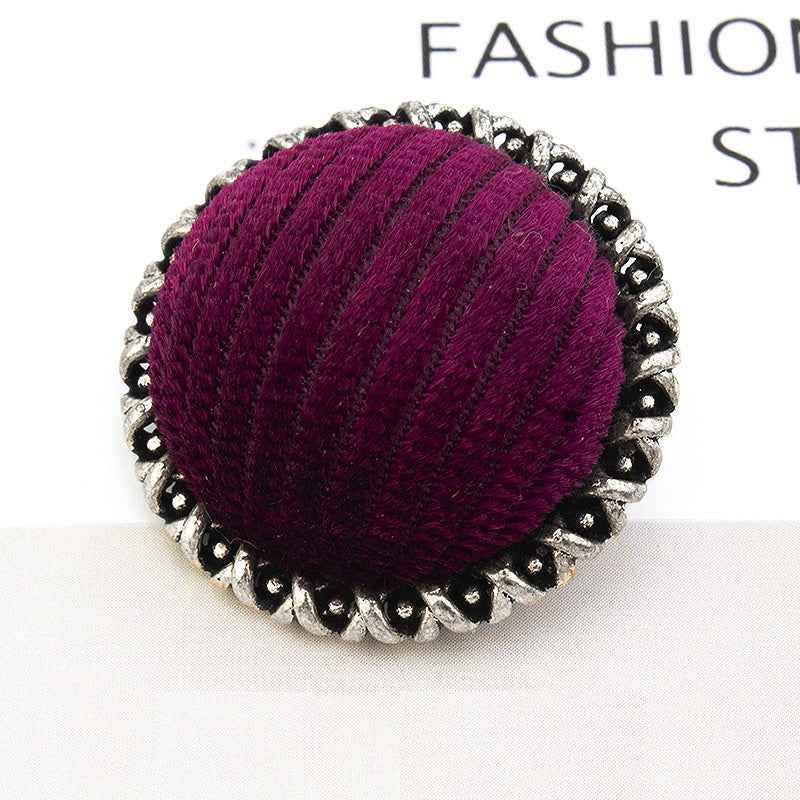 Red velvet-wrapped metal button, lace-edged scalloped edge, textured fabric top