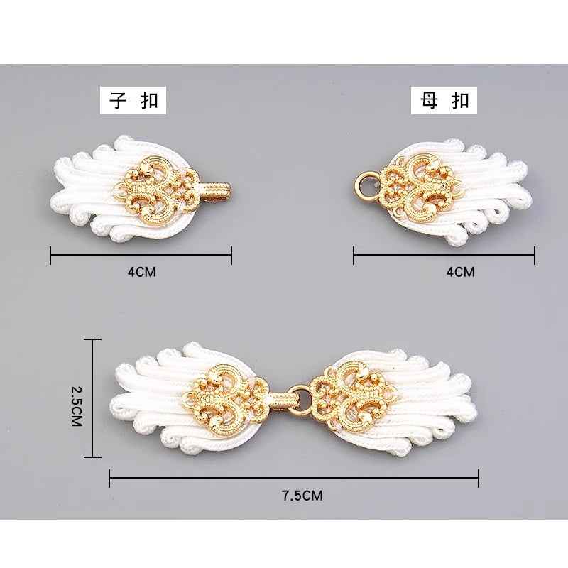 White Chinese frog button pair, gold clasp, braided tassels; 7.5 cm size shown