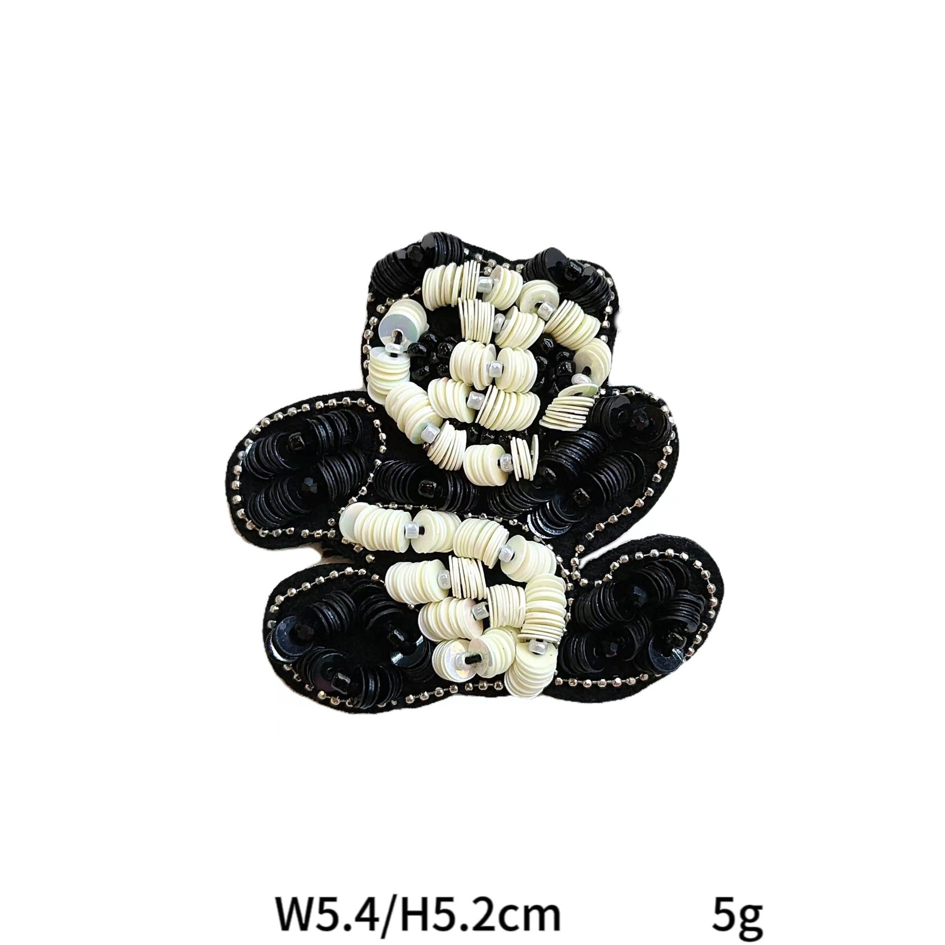 Black-and-white beaded bowtie fabric patch with looped bead pattern