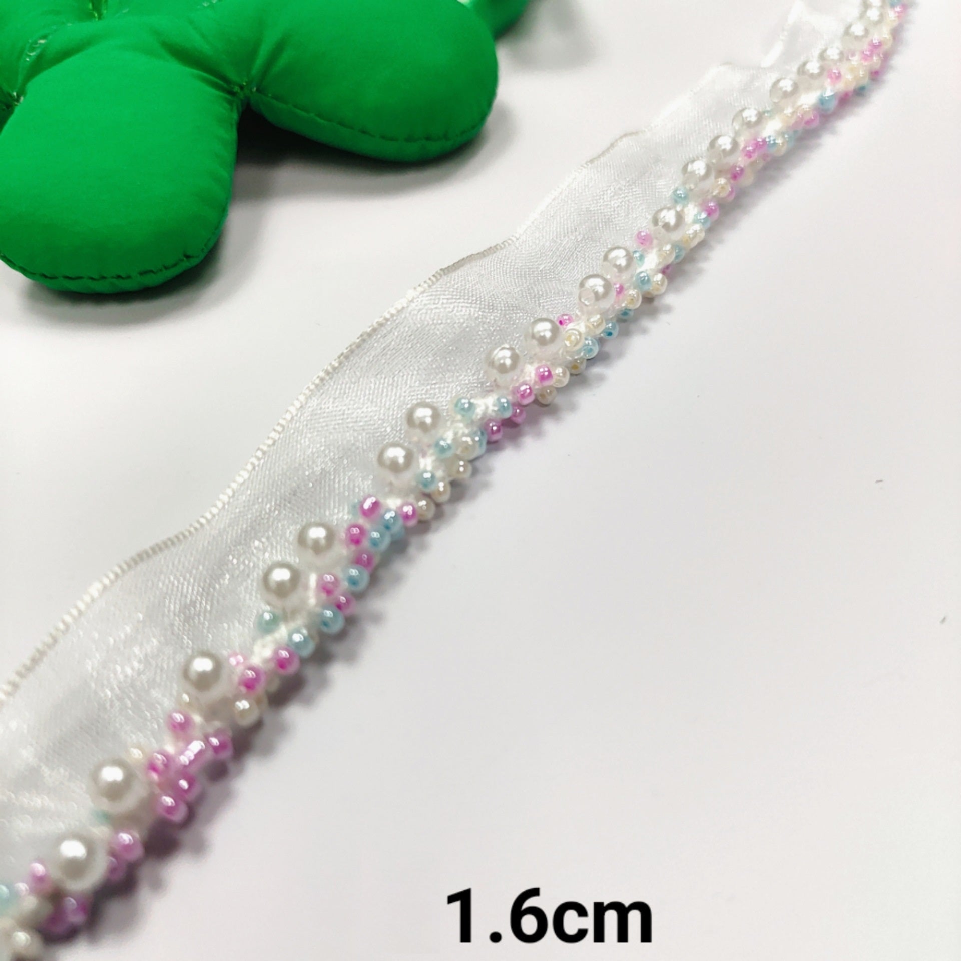 Crystal-encrusted lace ribbon with pearl trim, iridescent beads; 1.6cm wide