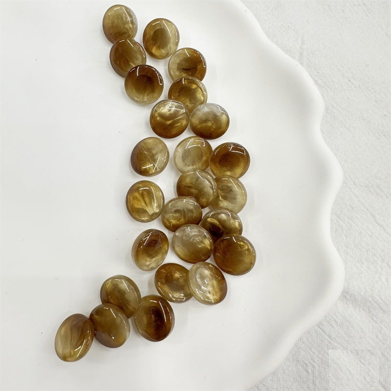 Round resin shank buttons in amber/golden tones, 11.5mm