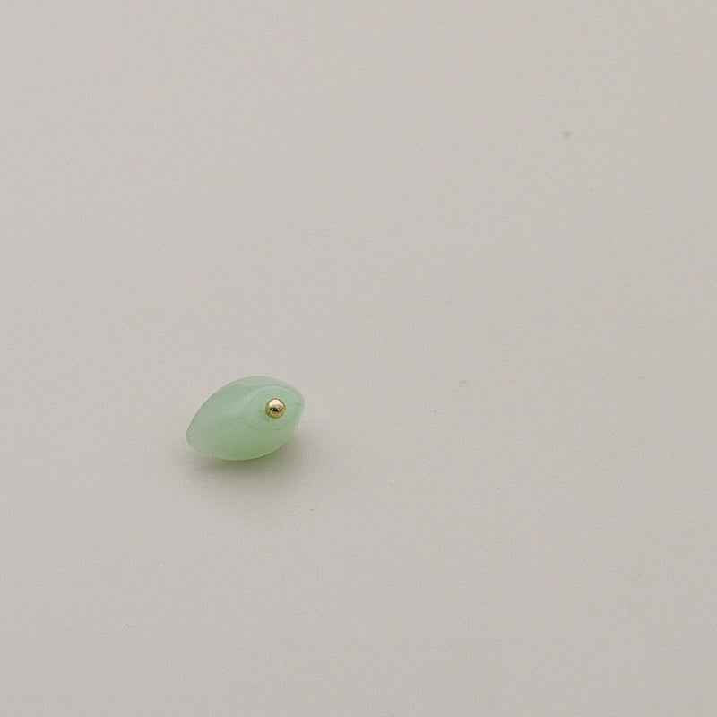 Light green translucent resin shank button with gold-tone center