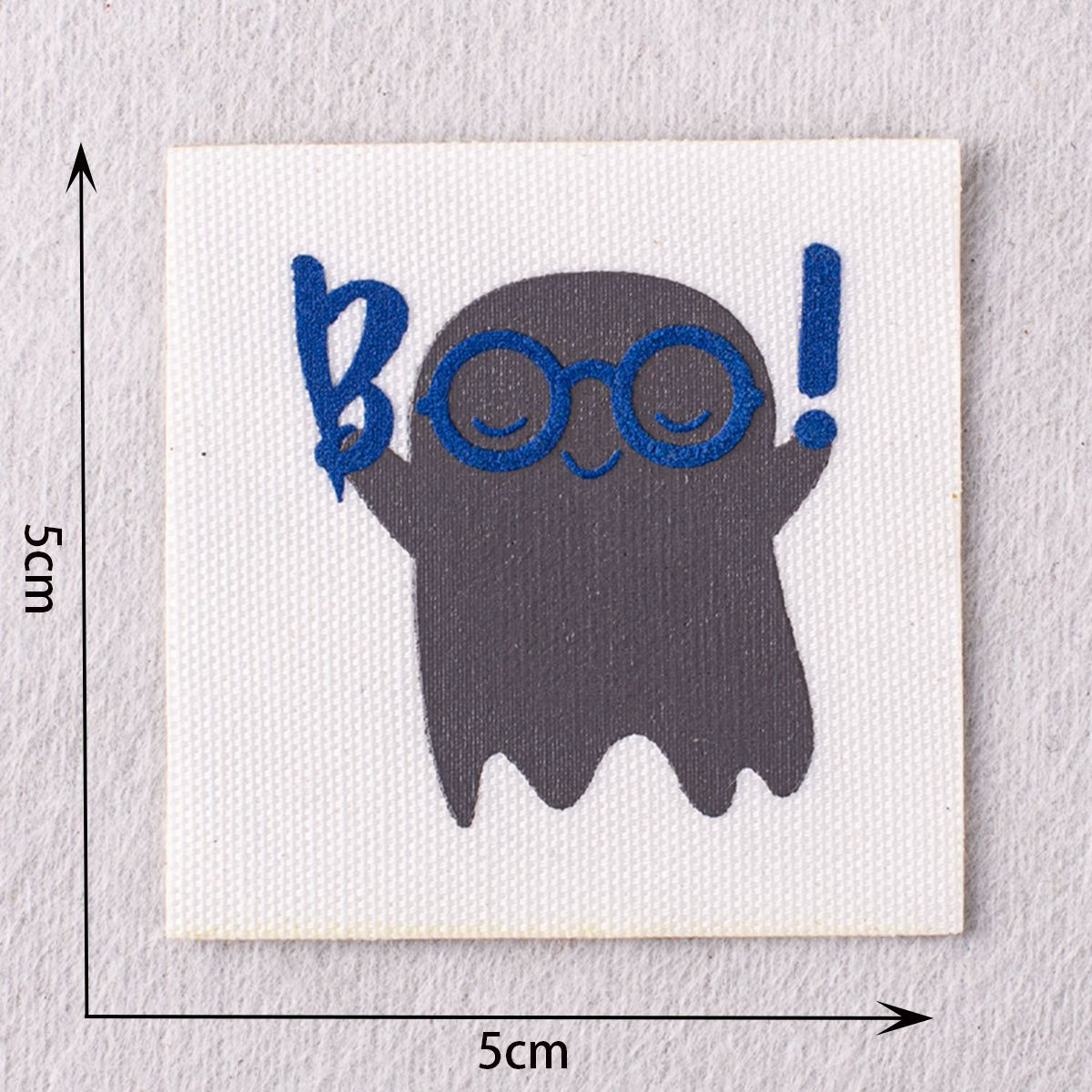 Grey cat patch with blue glasses and “BOO!” lettering