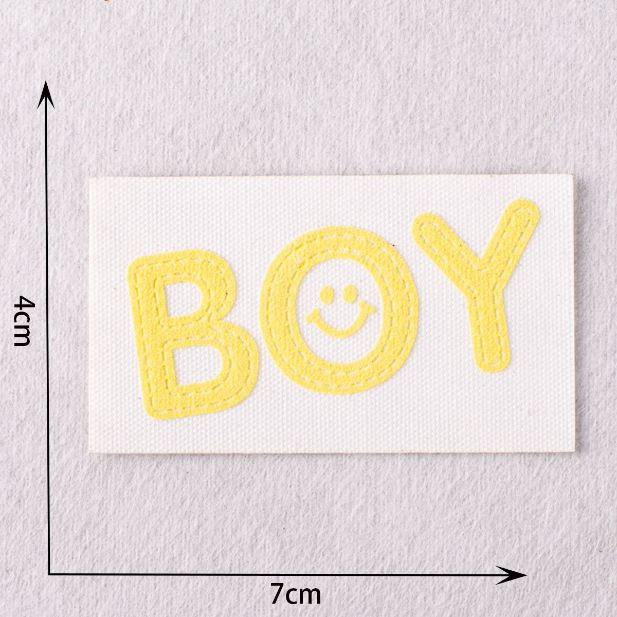 Yellow “BOY” patch with smiling face circle in the middle