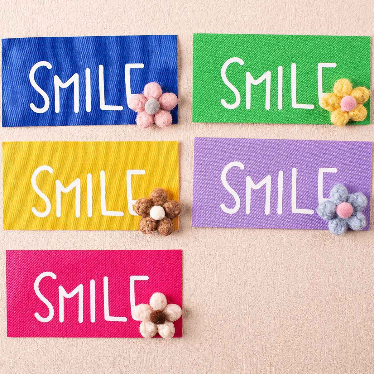 SMILE fabric badge set with flower embellishment—blue, green, yellow, purple, pink