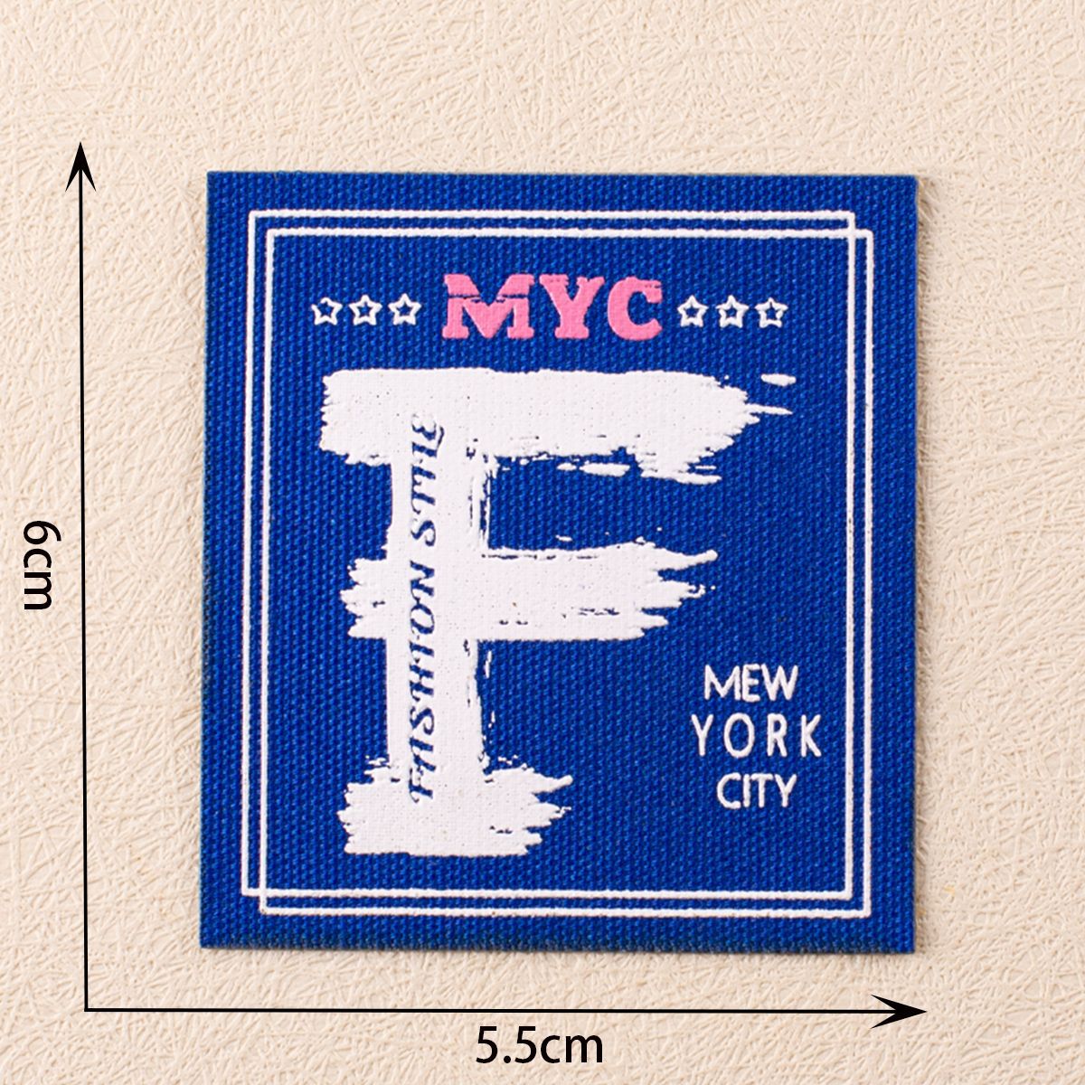 Blue square NYC fabric label with white map silhouette and 'New York City' text