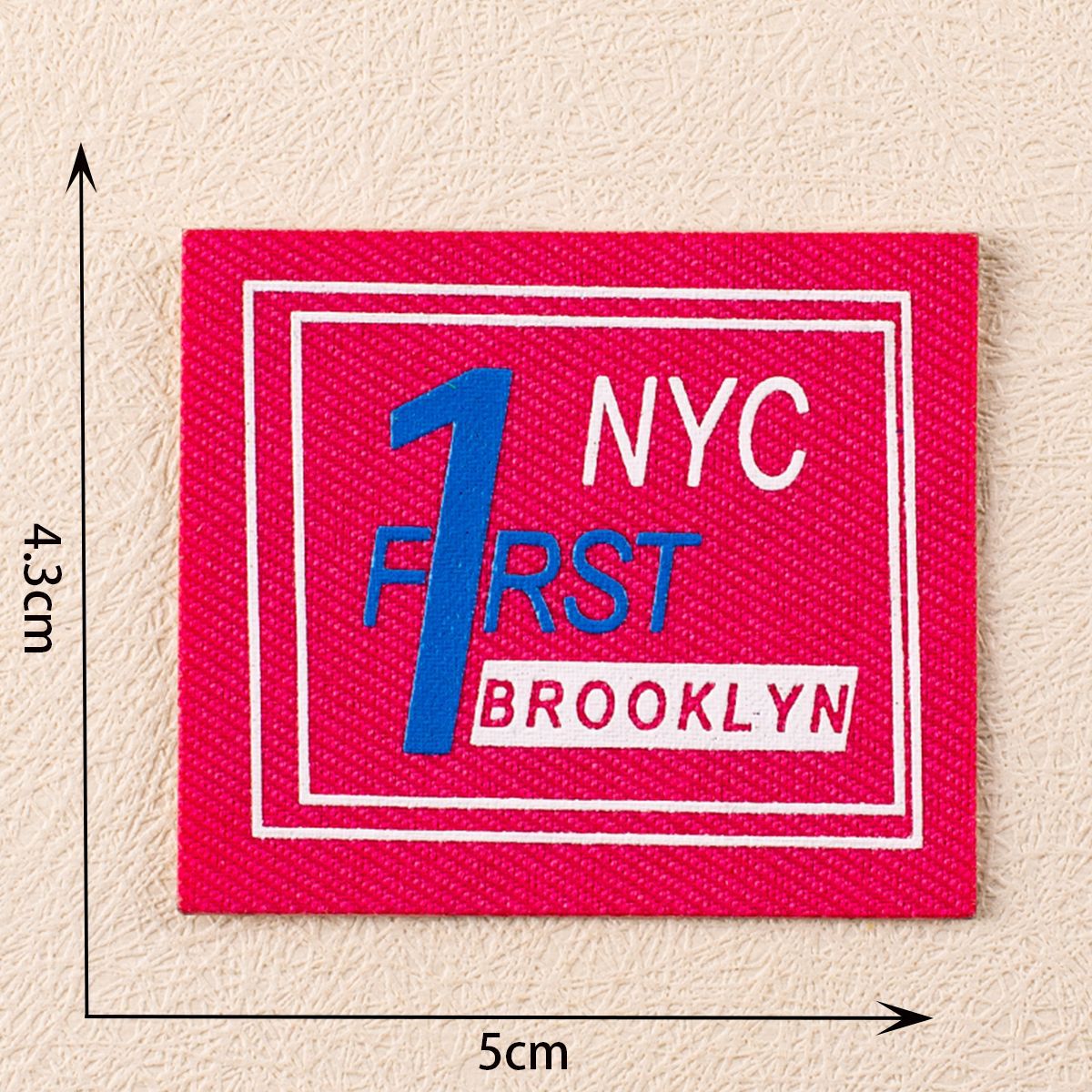 Red square fabric label with 'NYC F1rst Brooklyn' graphic, self-adhesive