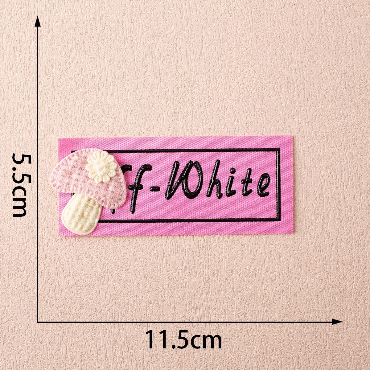 Off-White fabric label on pink with mushroom appliqué and flower detail