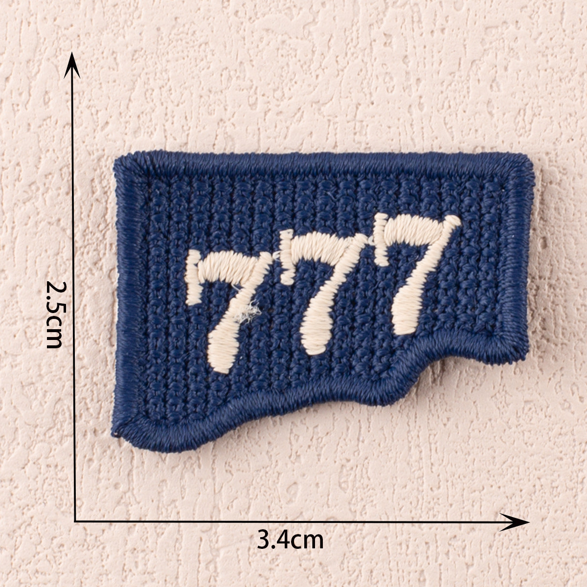 Blue fabric patch with white numbers 1 7 7, rounded cut shape, 3.4cm x 2.5cm.