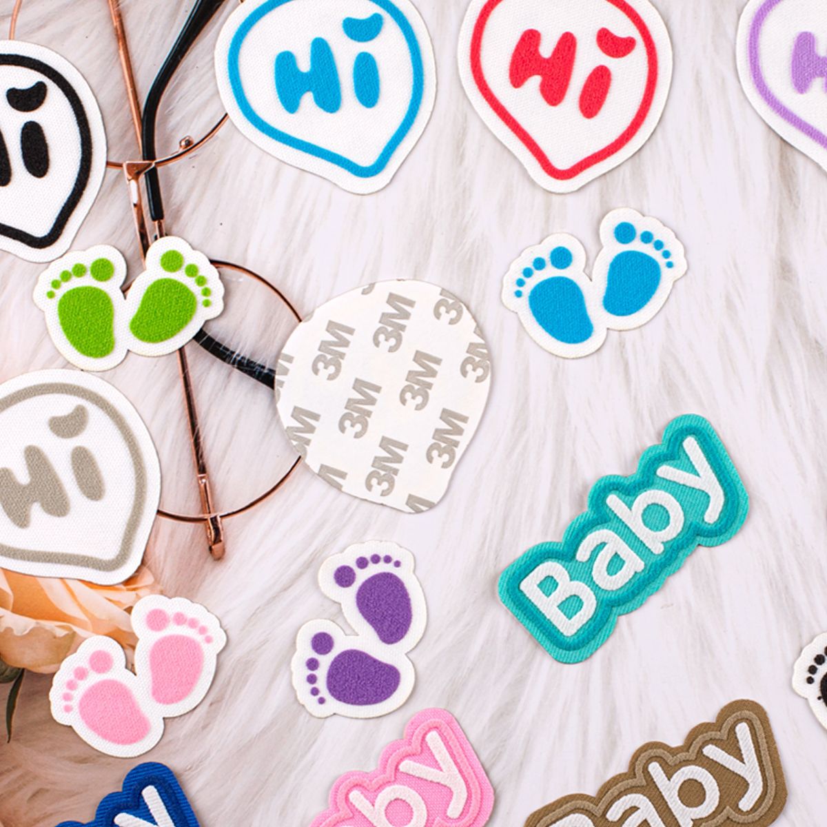 Self-adhesive 3M patches: purple/green footprints and 'Baby' letters on white felt