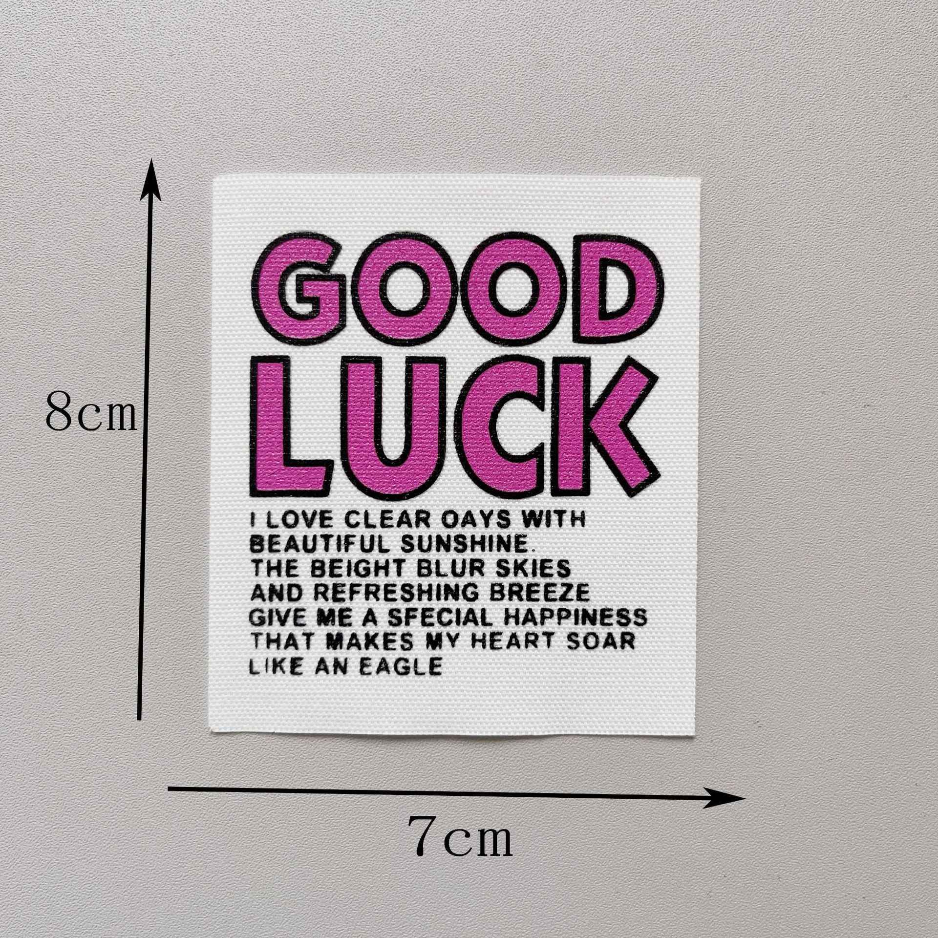 “GOOD LUCK” fabric patch, magenta/pink letters on white, 8x7cm