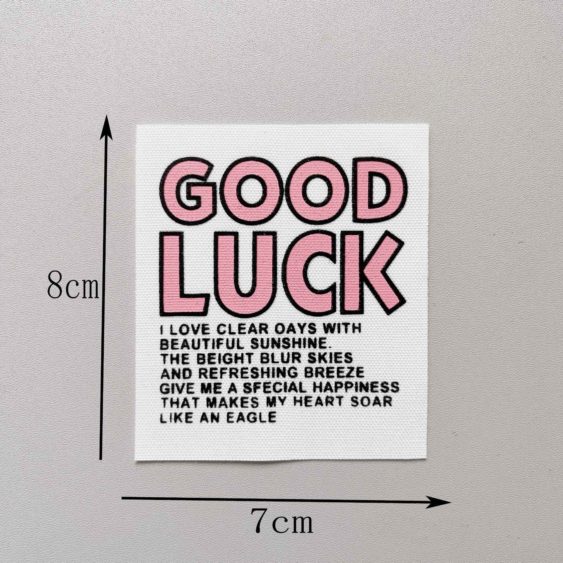 “GOOD LUCK” fabric patch, pink letters with dark outline, 8x7cm