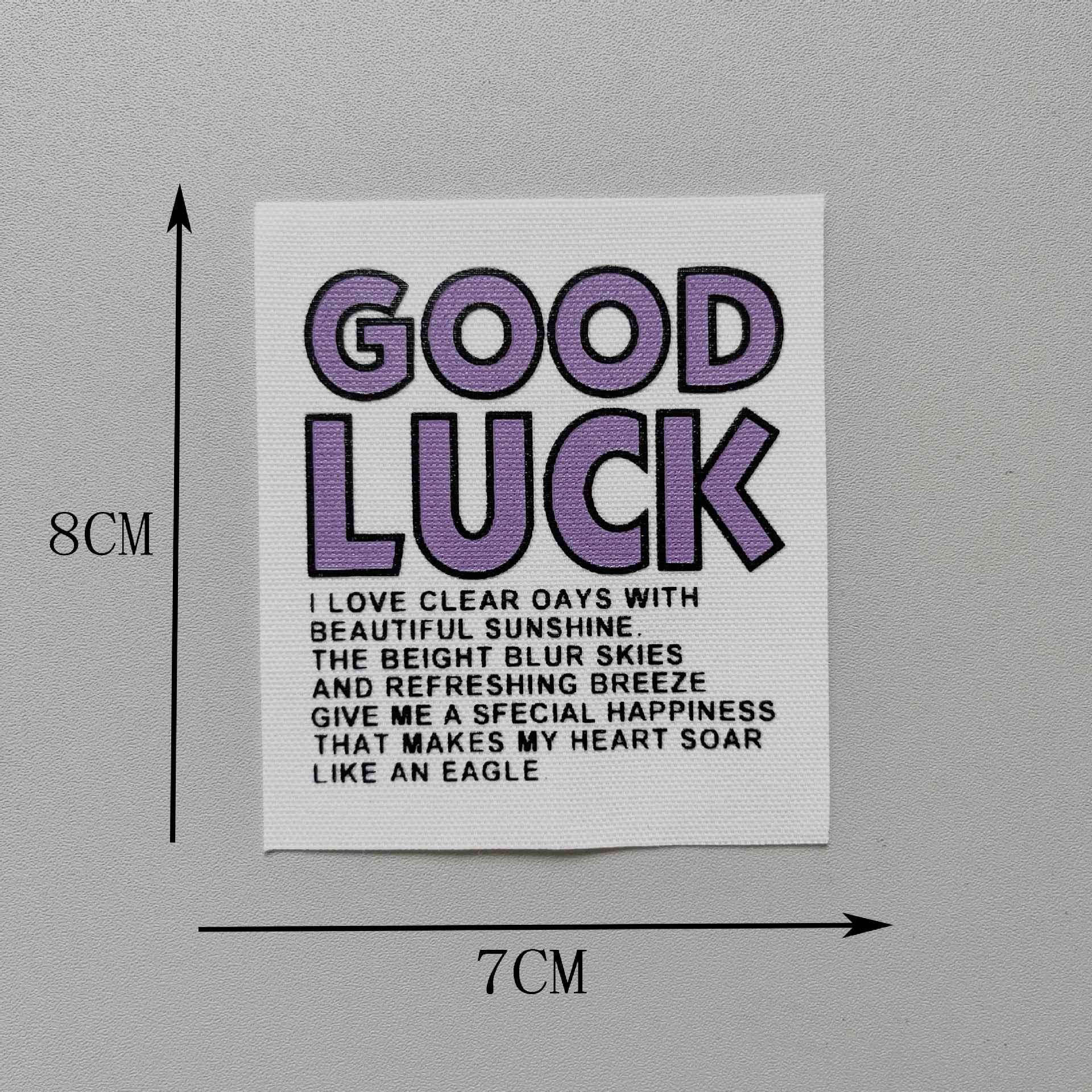 “GOOD LUCK” fabric patch, purple text on white, 8x7cm