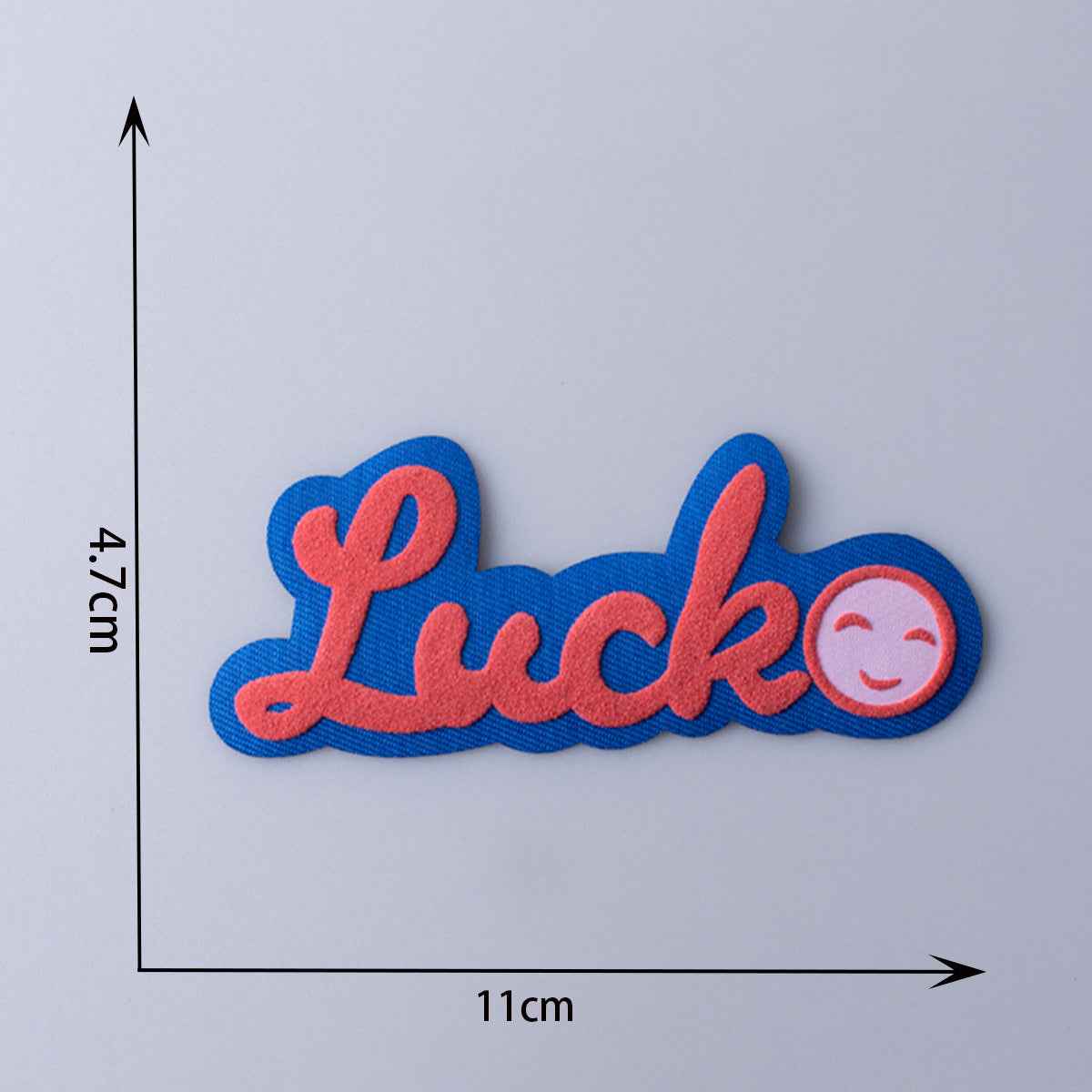 Luck 3D fabric patch with blue letters, red outline, and smile icon