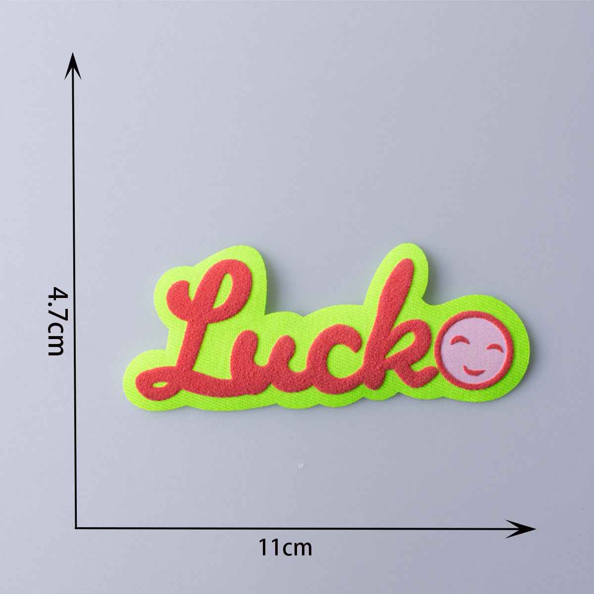 Luck 3D fabric patch with neon green letters, red outline, and smile icon