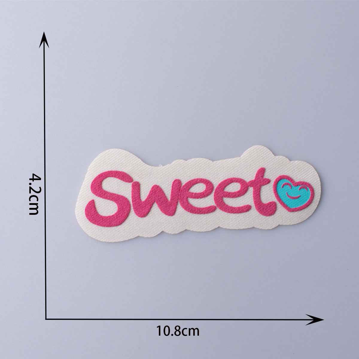 “Sweet” fabric patch, white with pink embroidered letters and swirl detail