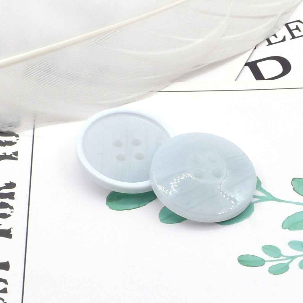 Round 4-hole light blue/white resin coat buttons with pearl-look edge detail