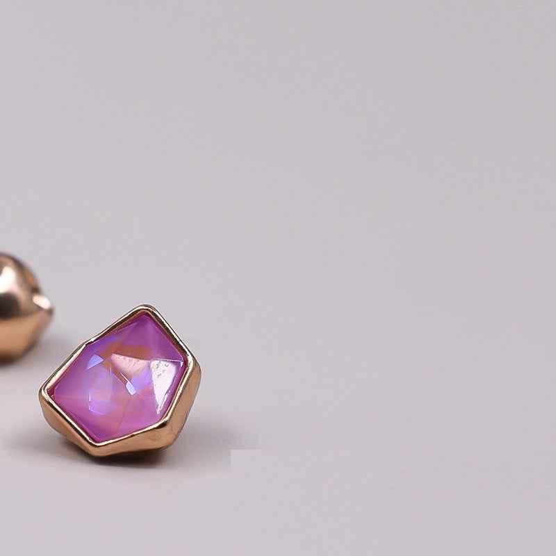 Irregular rhinestone button with lavender faceted stone and gold-tone edges