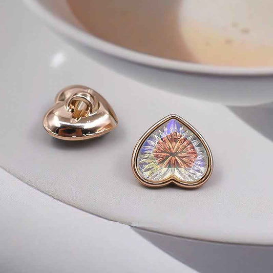 Heart-shaped shank button: iridescent front in blue; reverse shows metal shank