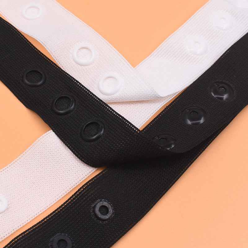 White and black snap fastener tape strips with round press-stud buttons
